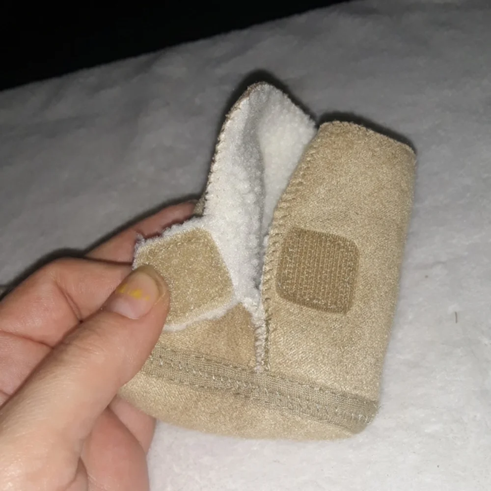 Newborn Tan soft baby boots with warm inner layer.